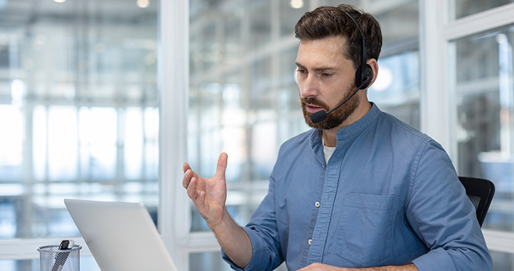 Man with headset on a laptop