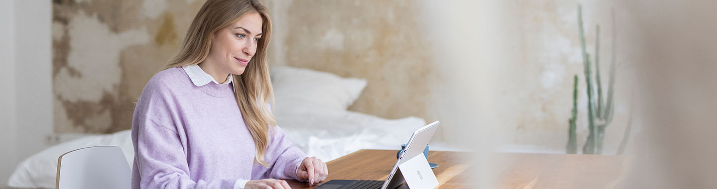 Woman sitting on table working on laptop