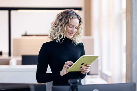 Friendly woman holding a tablet.