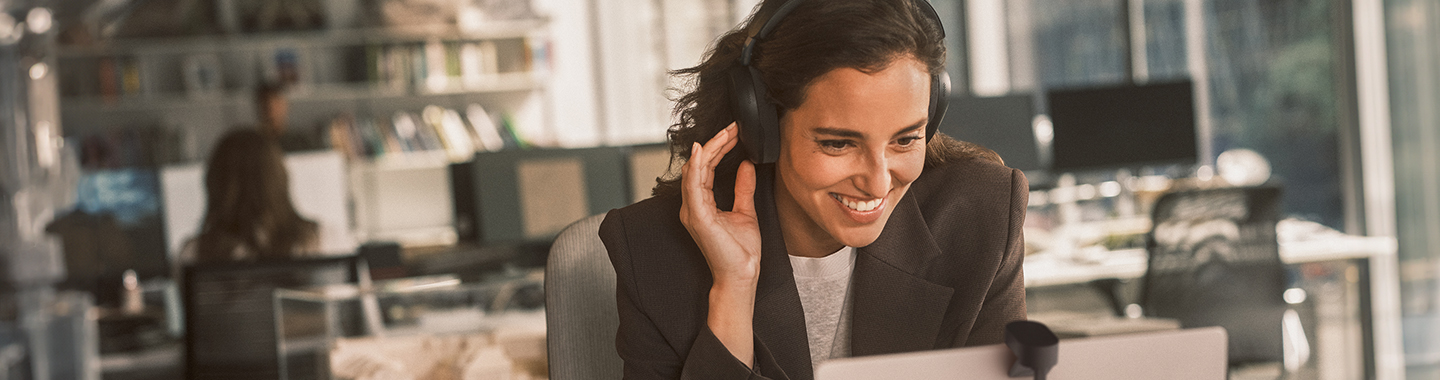 Jabra Markenshop, Frau im Büro beim Telefonieren und Arbeiten.