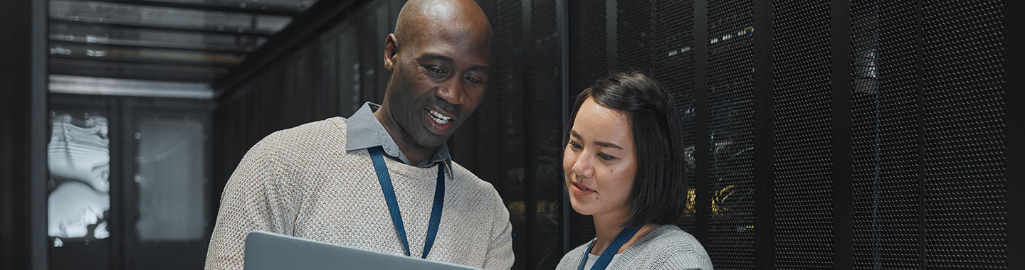 Man and woman looking at notebook