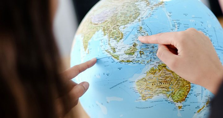Fingers pointing on globe