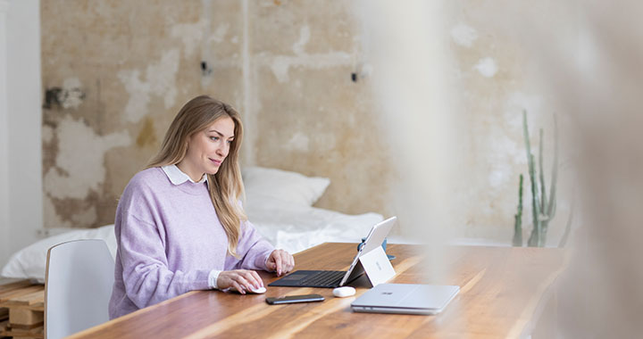 Woman sitting on table working on laptop
