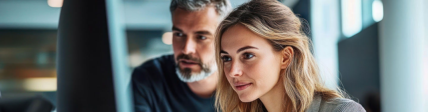 Man and woman looking at monitor